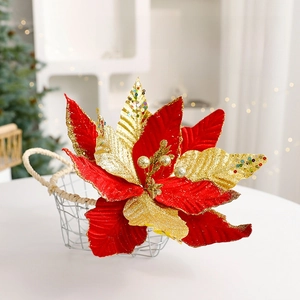 Sparkling red and gold poinsettia flowers in a decorative basket for Christmas decor