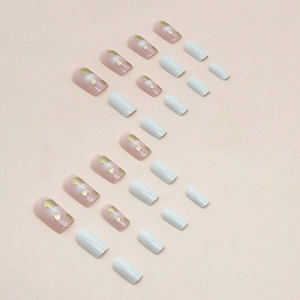 Medium square press-on nails in pink and white with gold heart patterns and dots