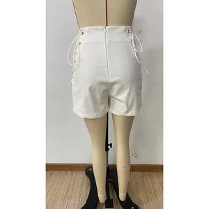 Rear view detail of white high-waist shorts featuring side lace-up design and zipper