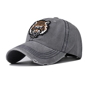 Distressed grey washed cotton baseball cap with detailed tiger head embroidery patch