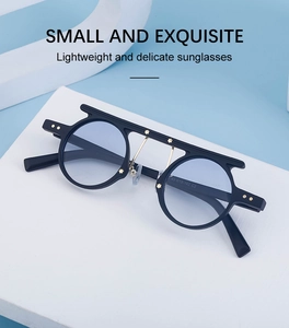 Close-up of black round sunglasses featuring gold star accents and 45-19-142 temple specs