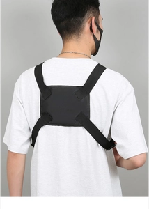 Detailed view of adjustable tactical chest rig with smartphone holder on model back