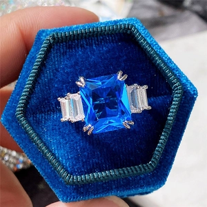 Macro shot of a 10x12 rectangular blue zircon ring in a blue velvet jewelry box