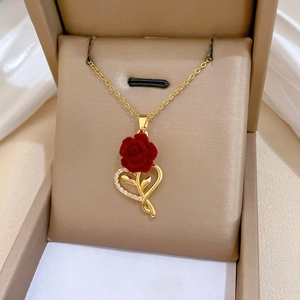 Close-up of heart rose necklace with red velvet flower and sparkling crystals