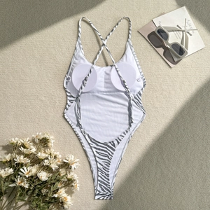 Close-up of white one-piece swimsuit with zebra print straps and built-in pads