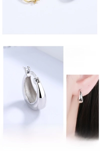 Detail view of oval silver earrings with S925 hallmark and minimalist smooth surface