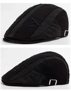 Close-up of black vintage beret featuring distressed edges and 3D letter A embroidery