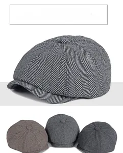 Detail of herringbone wool fabric on vintage newsboy caps in grey and brown colors