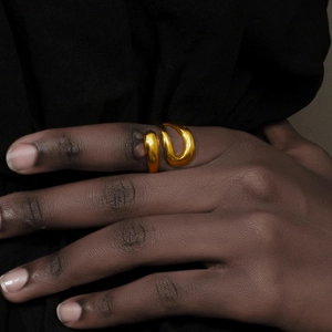 Macro detail of the triple-layered 18K gold plated snake ring showing mirror finish