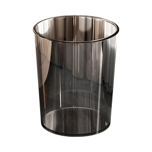 Minimalist transparent smoky grey cylindrical waste bin with a modern luxury design