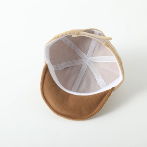 Detailed interior of corduroy baby cap showing soft velvet lining and reinforced stitching
