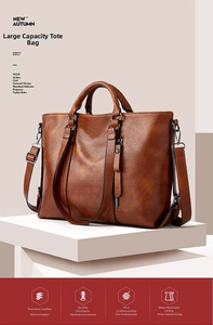 Dettaglio della pelle vintage e della cerniera laterale su una borsa tote marrone capiente