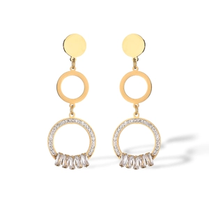 Detailed macro shot of gold plated earrings featuring geometric circles and zircon fringe