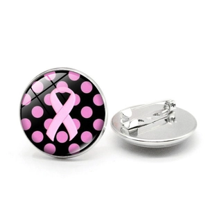Detailed view of pink ribbon breast cancer awareness brooch with polished glass dome