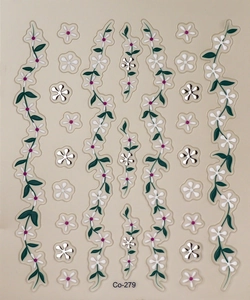 Macro shot of Co-279 floral nail art stickers with white petals and silver metallic accents