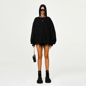 Front view of black cotton zip-up sweatshirt with cross design and distressed shorts