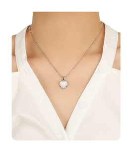 Close-up of heart pendant necklace with pearlescent inlay on a model neck