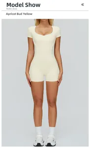 Front view of an apricot yellow sports romper with white piping and slim fit design