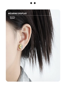 Detail of two-tone geometric lava texture earrings worn on a model for display