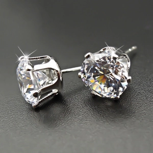 Macro detail of silver butterfly earrings with four-prong set sparkling zircon stones