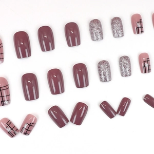 Sparkly glitter press-on nails in mauve purple and silver with black geometric lines