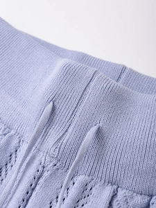 Detail of lavender knit fabric featuring waist drawstring and ribbed hem with pointelle mesh