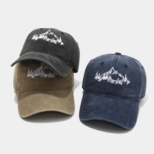 Detailed embroidery of mountains and forests on washed cotton vintage baseball caps