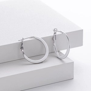 Minimalist 925 sterling silver hoop earrings displayed on white geometric blocks