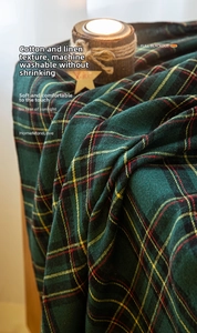 Detail of red and green plaid blackout curtain with texture and festive decorations