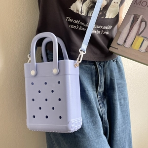 Close-up of a lavender EVA tote bag with ventilation holes and white strap buckles
