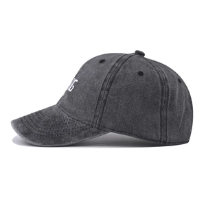 Close-up of white NG embroidery on dark gray washed cotton vintage baseball cap