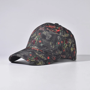 Detail of a black baseball cap with vintage Eiffel Tower prints and colorful motifs