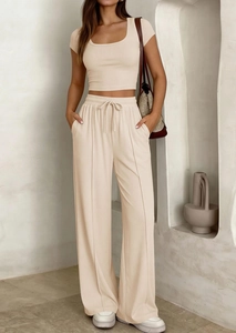 Détail d'un ensemble beige en maille côtelée avec haut court et pantalon large taille haute