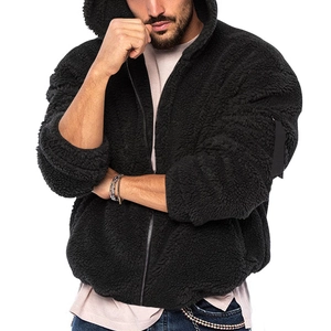 Detail of black polar fleece hooded jacket showing thick texture and zippered sleeve pocket