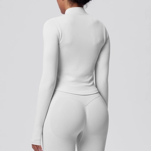 Rear view of white slim-fit ribbed yoga jacket showing tailored curve and athletic fabric
