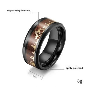 Detail of 9mm stainless steel wood inlay ring featuring golden deer and forest silhouette
