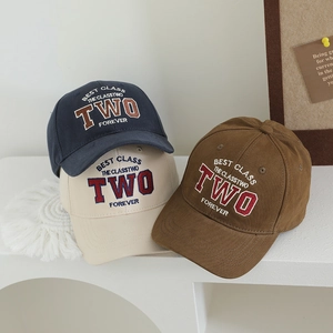 Set of three vintage embroidered kids baseball caps in navy, cream, and brown colors