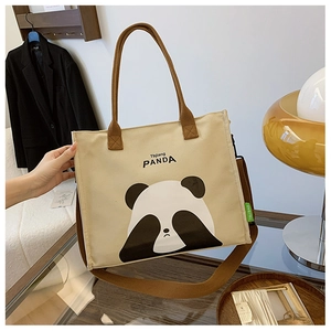 Detail of a beige canvas panda crossbody bag with brown straps and cartoon panda print