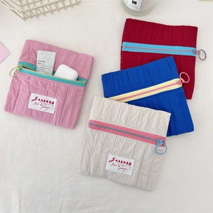 Detailed top view of colorful quilted nylon makeup pouches with zippers and rings