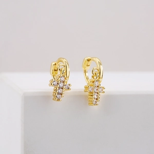18K gold plated copper cross hoop earrings with clear cubic zirconia on white stand