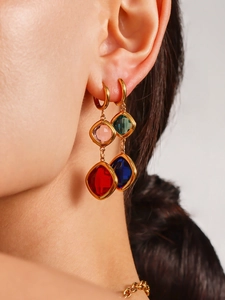 Close-up of luxury 18K gold earrings with colorful Czech glass drops on model