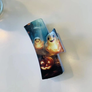 Halloween claw clip featuring spooky ghost and pumpkin prints on dark acrylic base