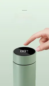 Detail of mint green smart thermos showing LED temperature display on black touch lid