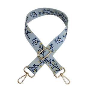 Adjustable floral pattern bag strap with blue blossoms and golden metal hooks