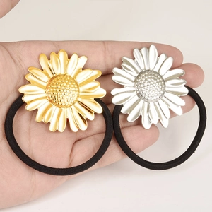 Daisy hair ties in gold and silver stainless steel finish on black elastic bands