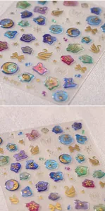 Detailed view of 3D aurora nail art stickers with embossed swan and shell patterns
