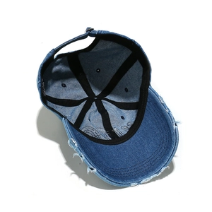 Inside view of distressed denim baseball cap with metal buckle and adjustable strap