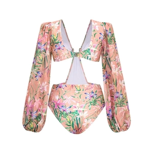 Detail view of floral lily print monokini with mesh ruffles and puff long sleeves