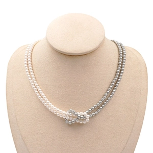 Elegant double-layered pearl necklace with white and grey beads in a knotted center design