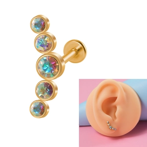 Macro view of 16g gold stainless steel stud earring featuring five opal stones on ear model
